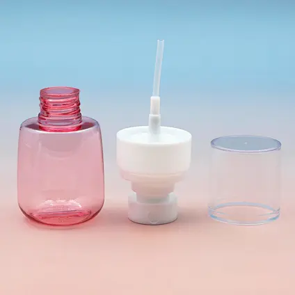 Disassembled pink fine mist spray bottle, showing the PET bottle, white pump assembly, and clear protective cap